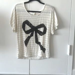 Cream flowy top with black bow and open back